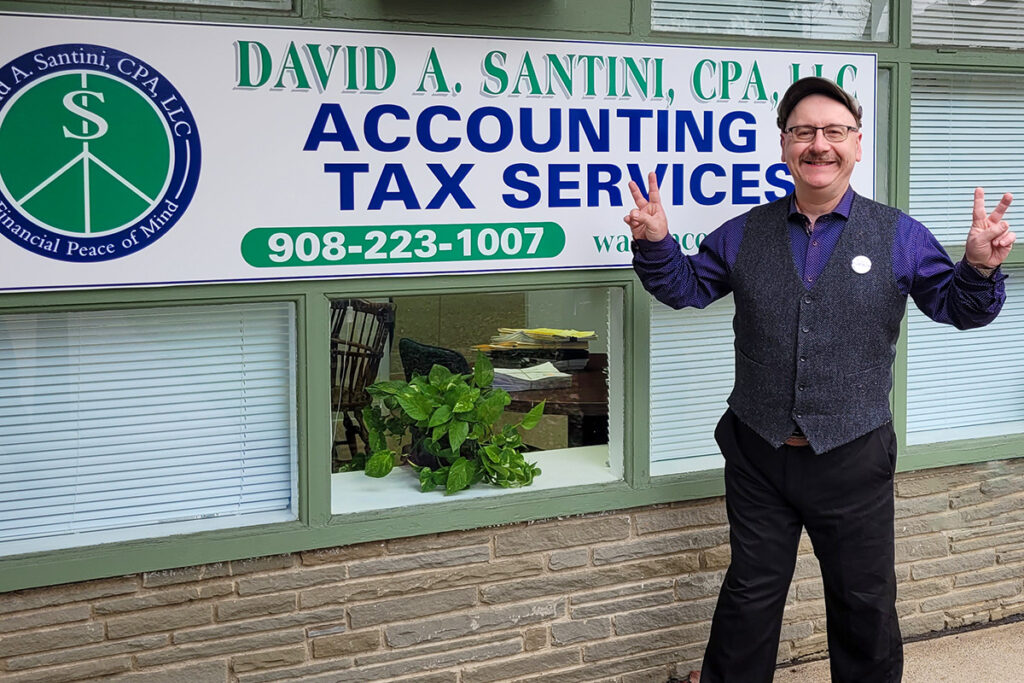 Photo of David Santini standing in front of his business