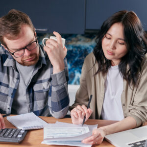Photo of man and woman looking over paperwork.