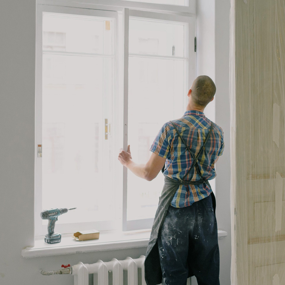 Workman installing a new window.
