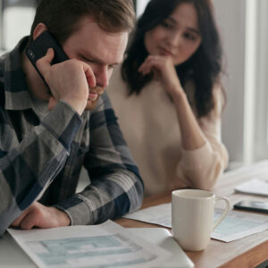 Photo of a couple doing taxes and looking stressed